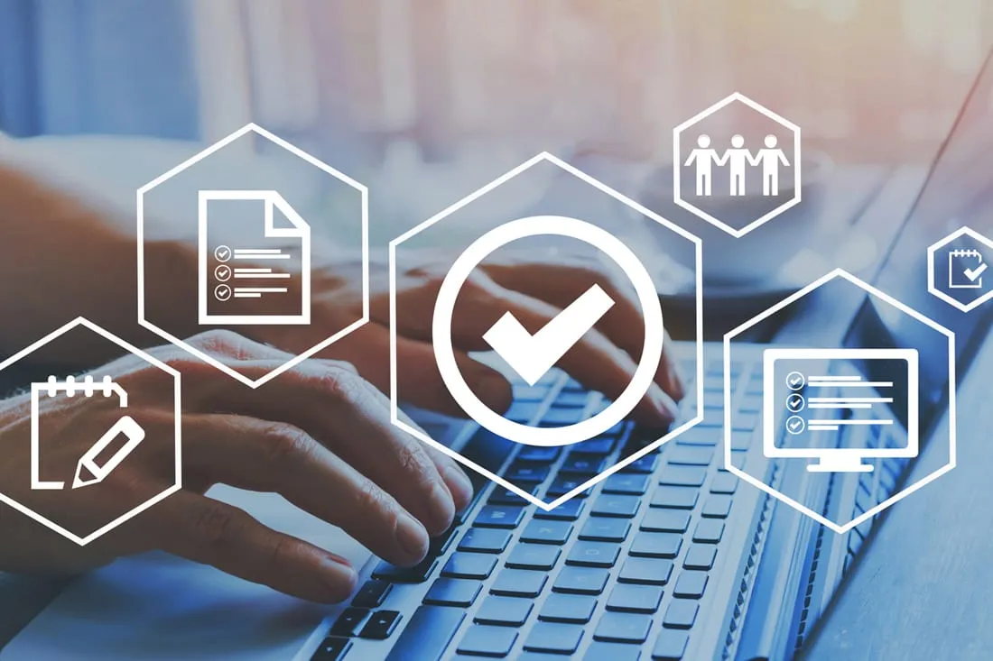 Hands typing on a laptop overlaid with document, checklist and team process icons